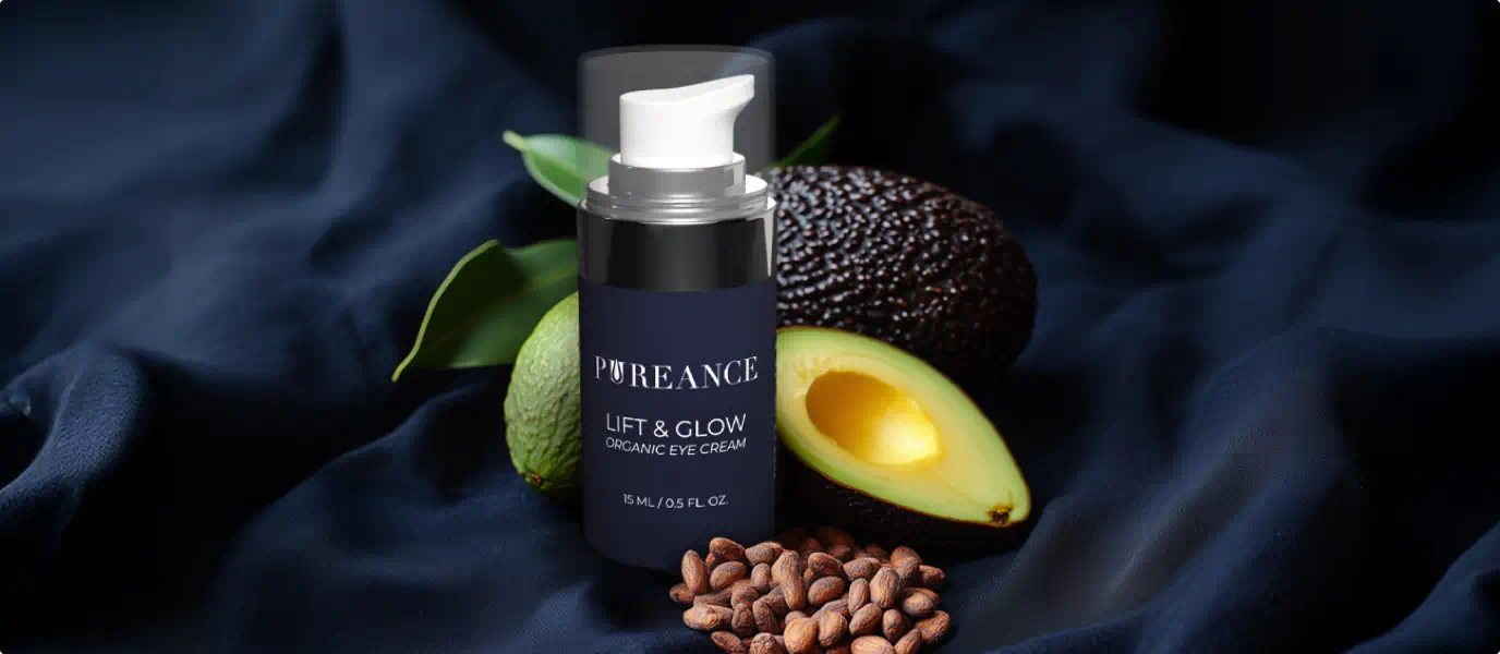 Pureance Lift & Glow eye cream with avocado and shea nuts on a dark fabric background