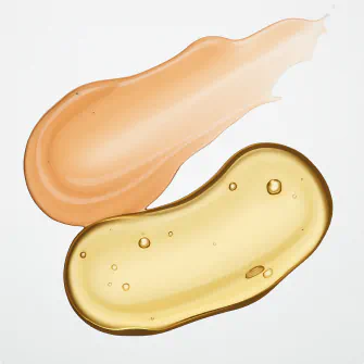 Two glossy skincare gel swatches—one peach-colored, one golden—on a white surface