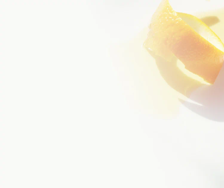 Orange peel curl beside a glossy pool of oil