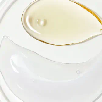 Close-up of two different skincare textures on a white surface