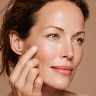 Close-up of woman gently touching her cheek